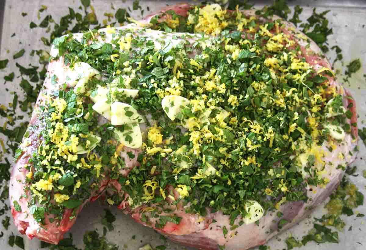 lamb shoulder covered with chopped herbs and lemon zest.