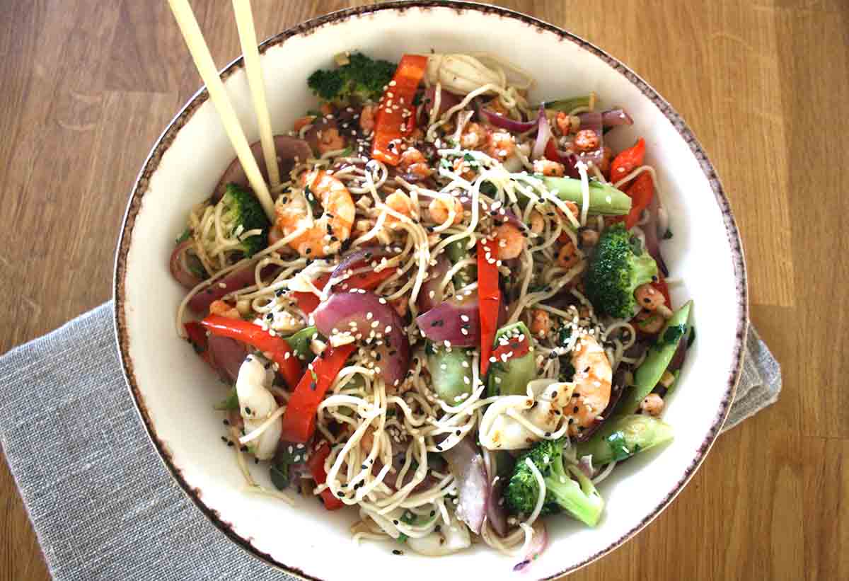 bowl of vegetable noodles with prawns and squid.