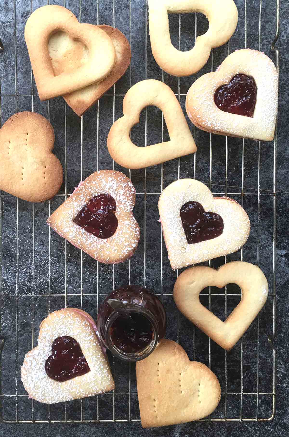 raspberry almond linzer cookies on a  baking rack  for the Valentine's day menu.