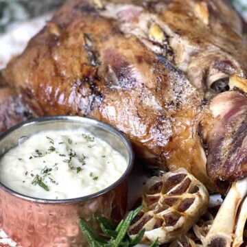 slow roast lamb shoulder and pot of onion sauce.