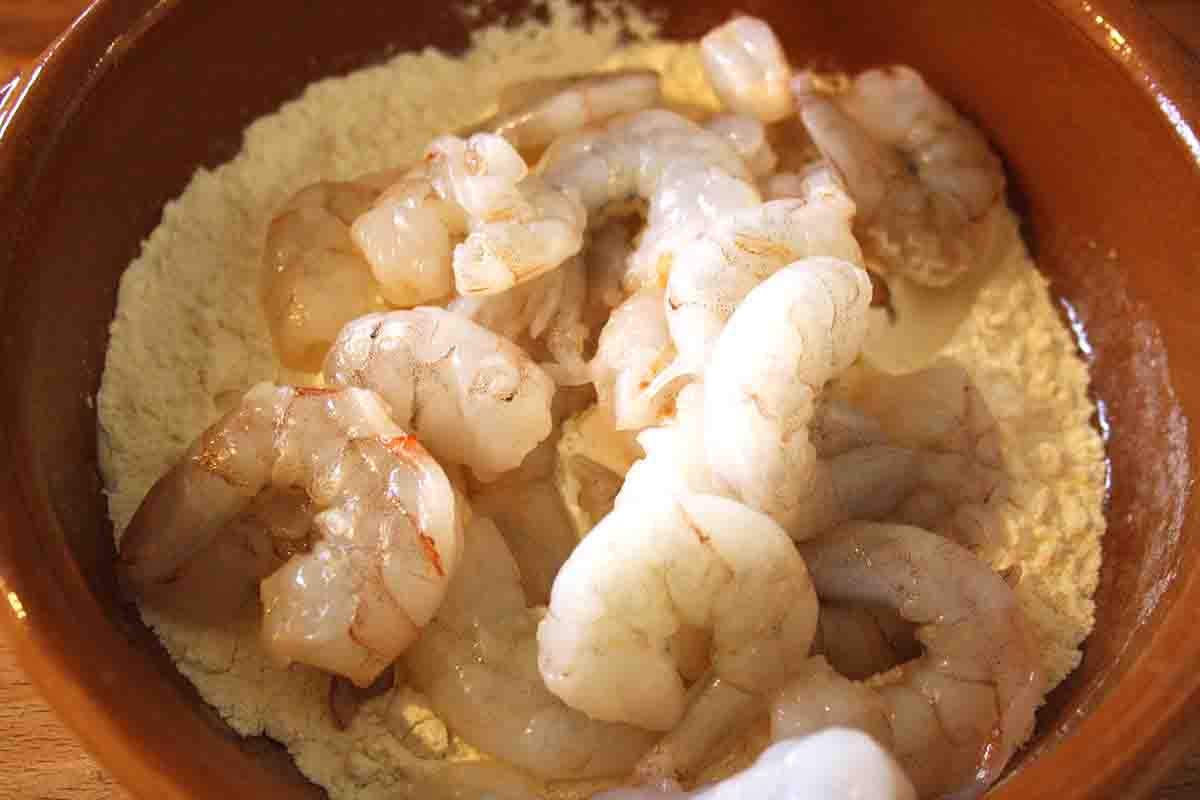 prawns ready to be mixed with flour in a bowl.