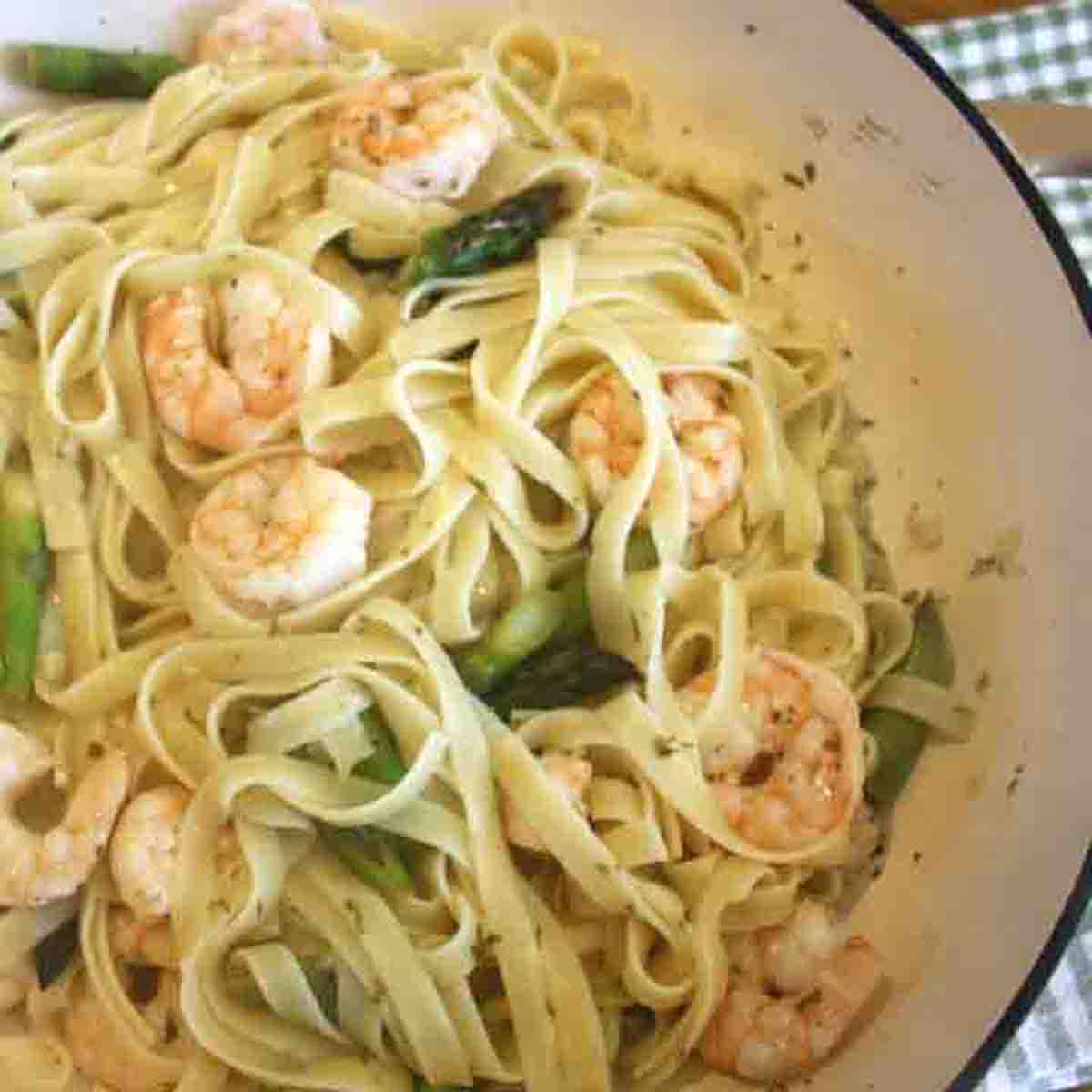 prawn linguini with asparagus in a dish.