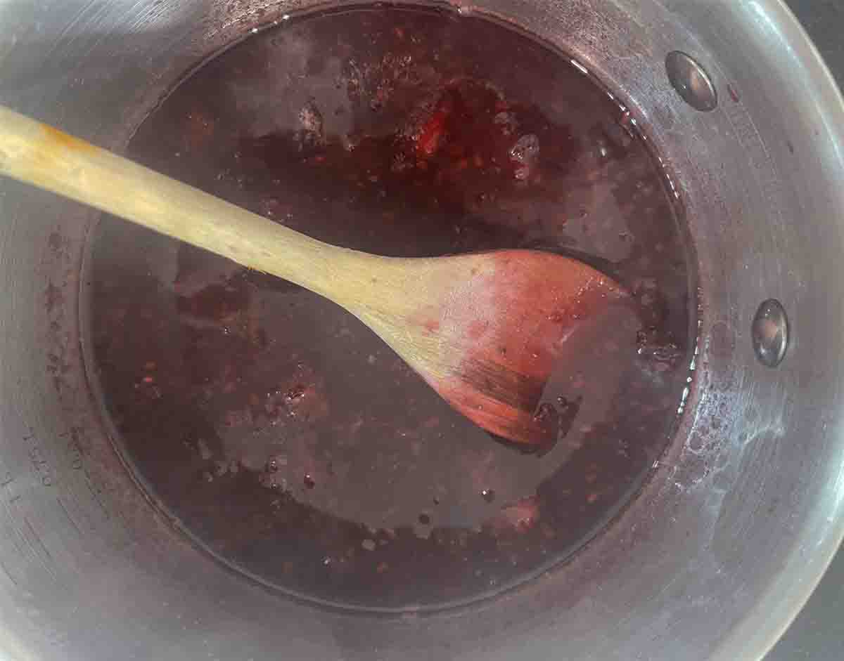 sauce cooking with mashed blackberries.