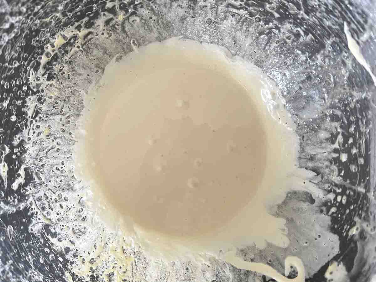 hot sugar and egg yolk mix in a bowl.