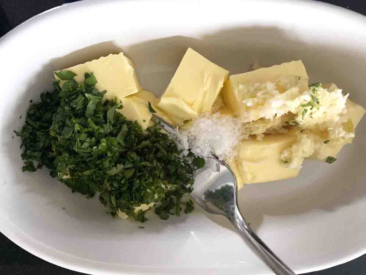 butter, parsley, garlic and seasoning in a bowl.