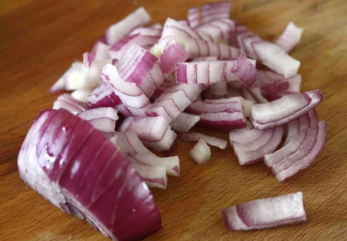 chopped red onion on a board.