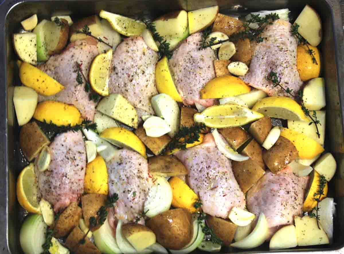 chicken and vegetables in a roasting tray ready to cook.