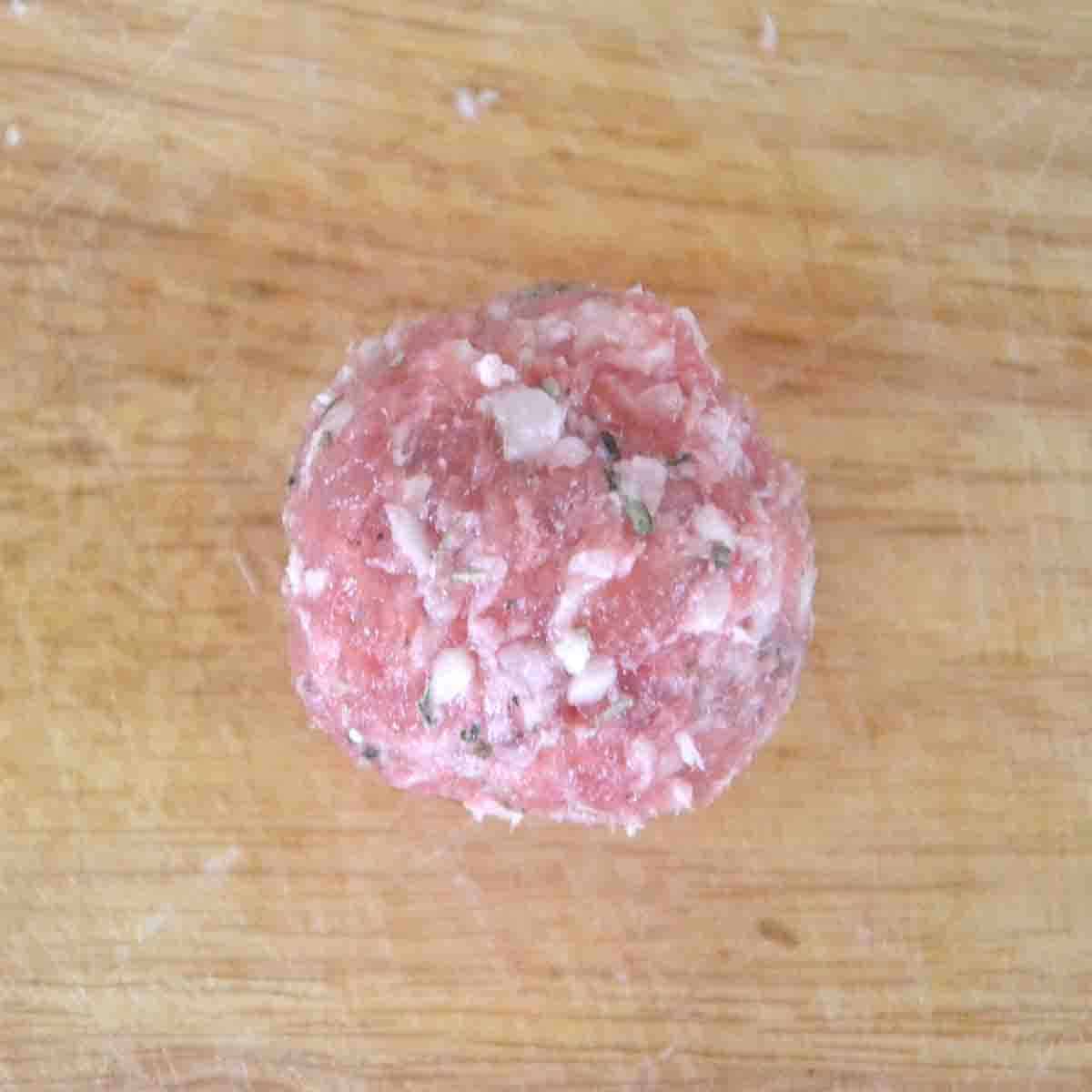 ball of sausage meat with egg inside.