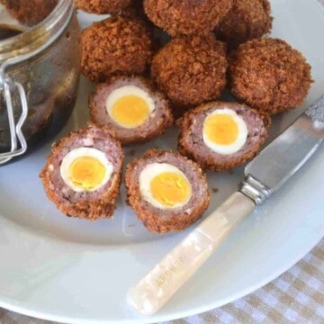 halved quail scotch eggs on a plate.