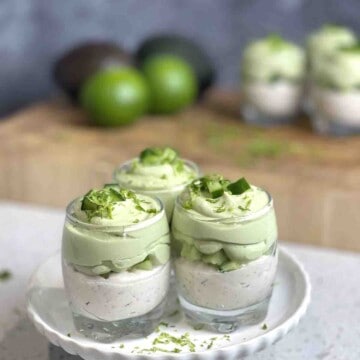 three smoked salmon mousse with whipped avocado layered in glasses.