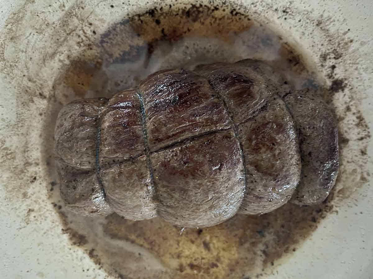 seared beef in a pan.