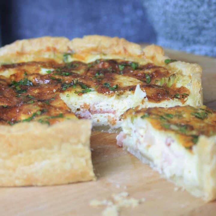 French quiche lorraine flan with a slice cut out.
