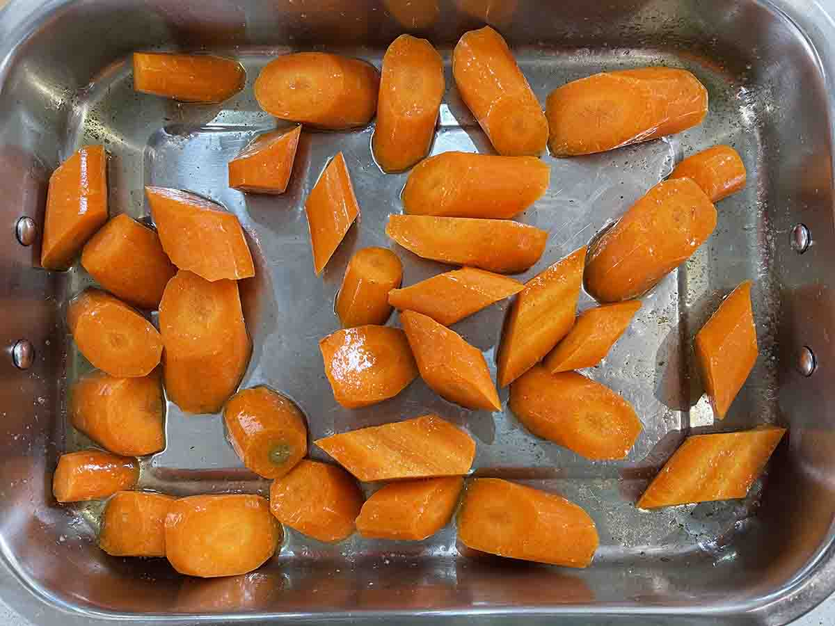 carrots in butter and oil in a rasting tray.