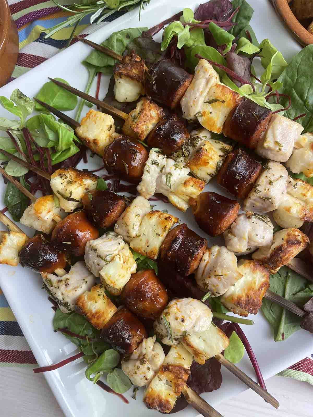 chicken skewers on a plate.