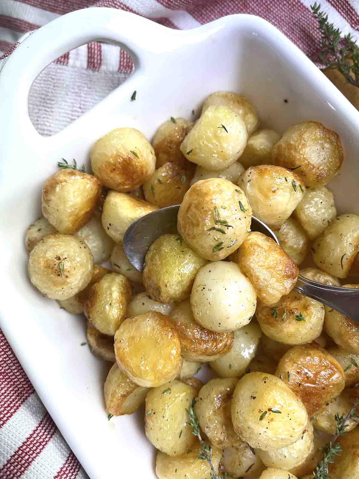 close up of pommes noisettes on a spoon.