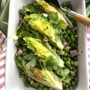French peas in a dish with lettuce on top.