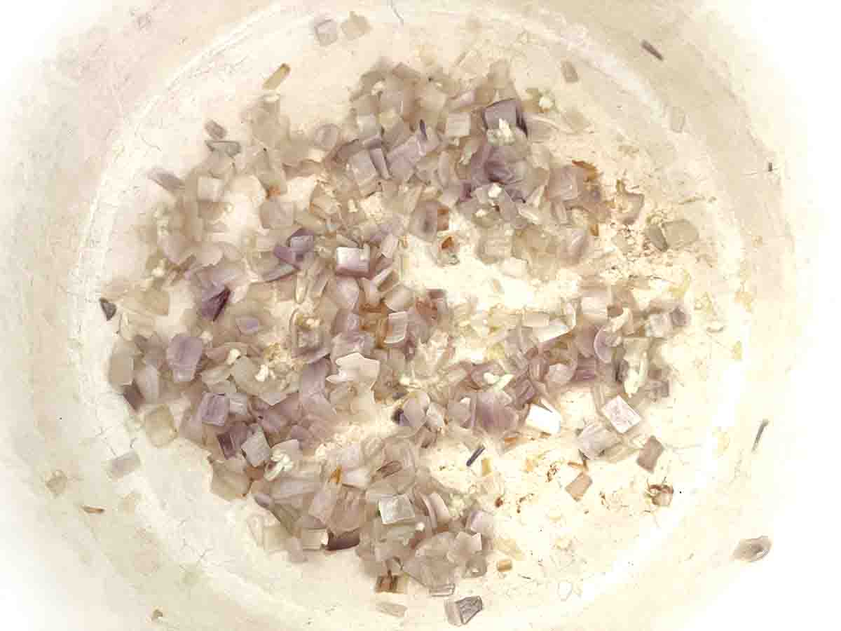 shallots frying in a pan.