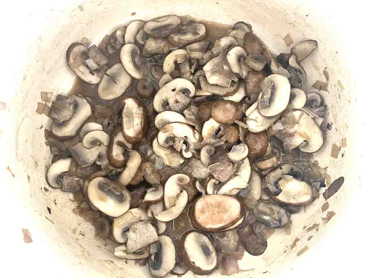 sliced mushrooms added to the pan.