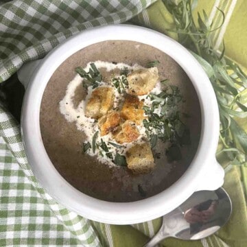 mushroom soup without cream in a bowl with croutons on top.