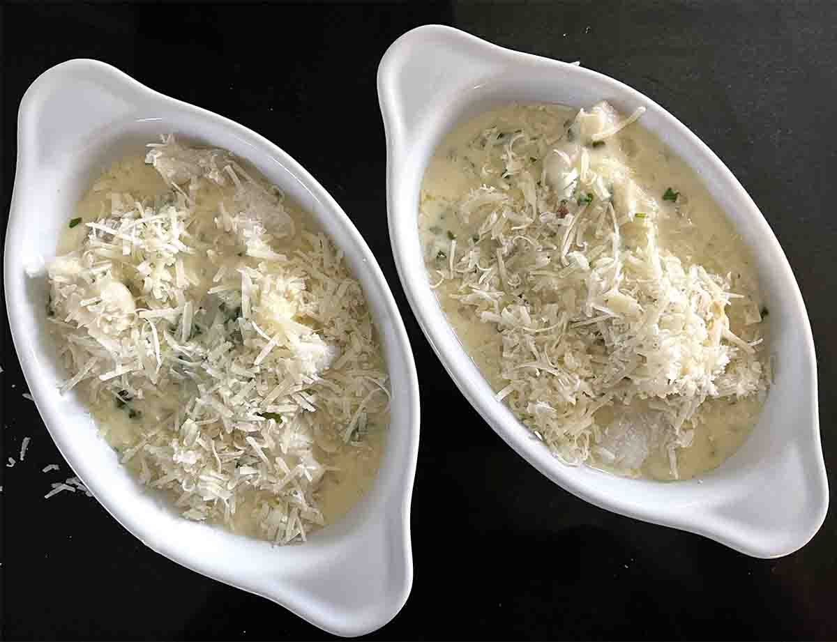 dishes with cream on top and cheese sprinkled over.