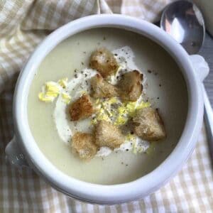 celery and leek soup in a white bowl.