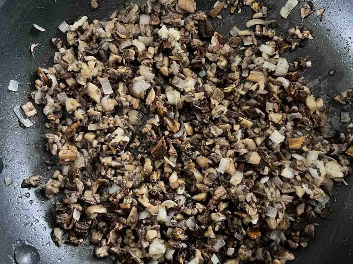 chopped mushrooms and shallots in a frying pan.