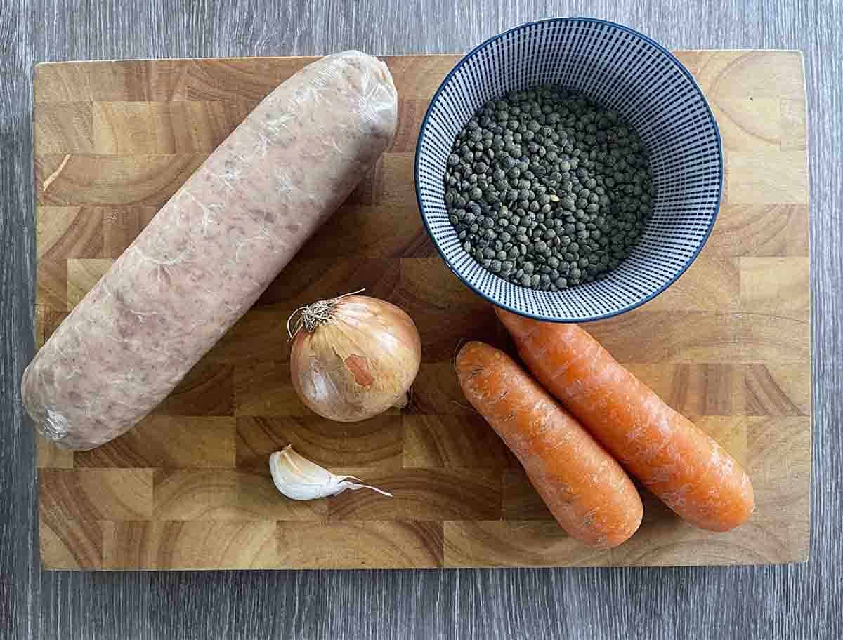 ingredients including sausage, lentils, onions and carrots.