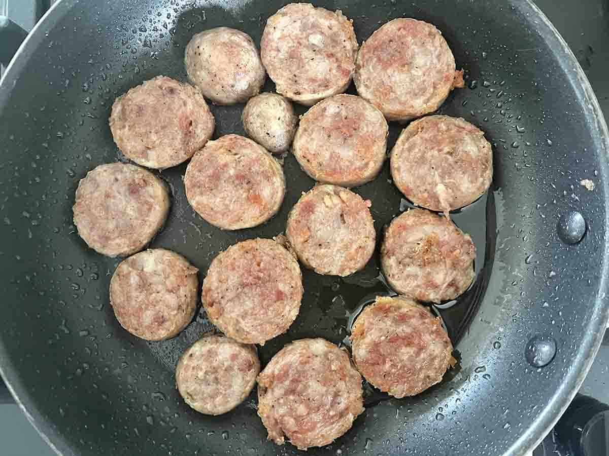 sausage slices frying on a pan.