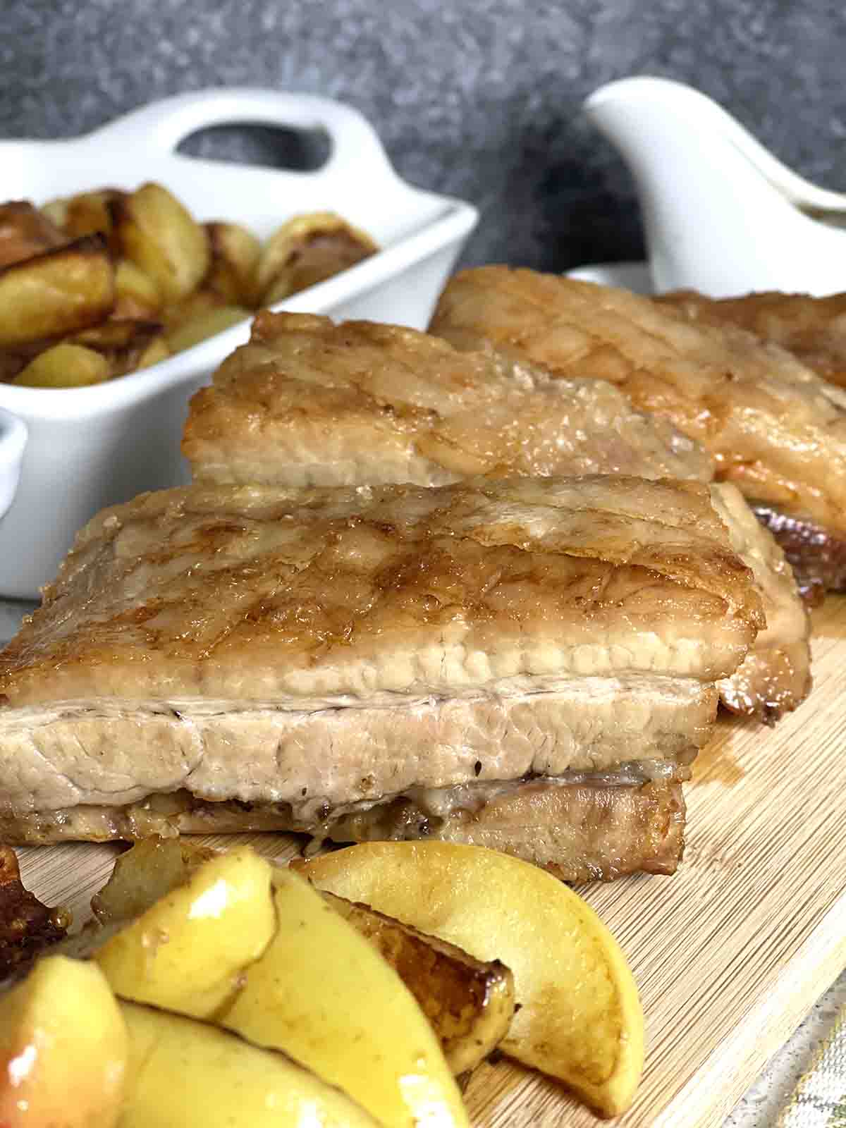 pork with apples on a board.