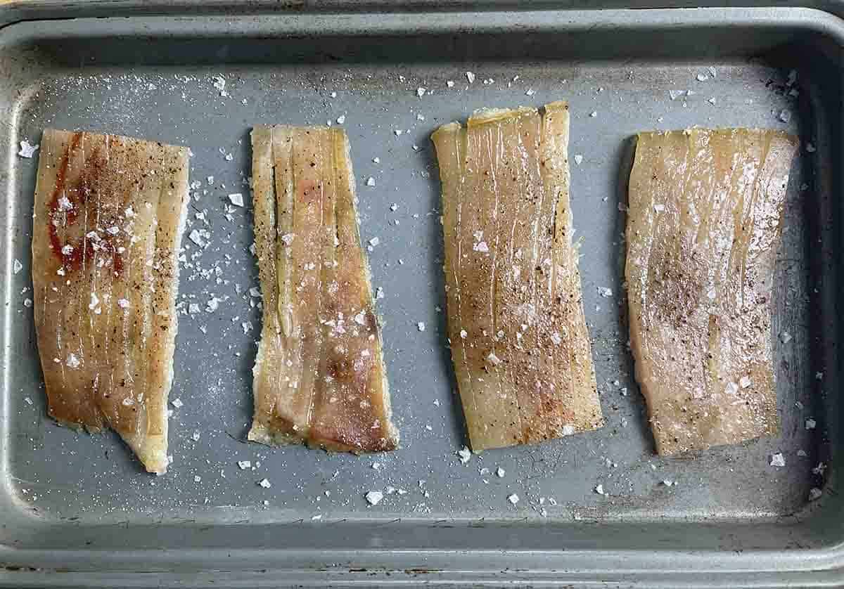 skin cut into portions on a baking tray.