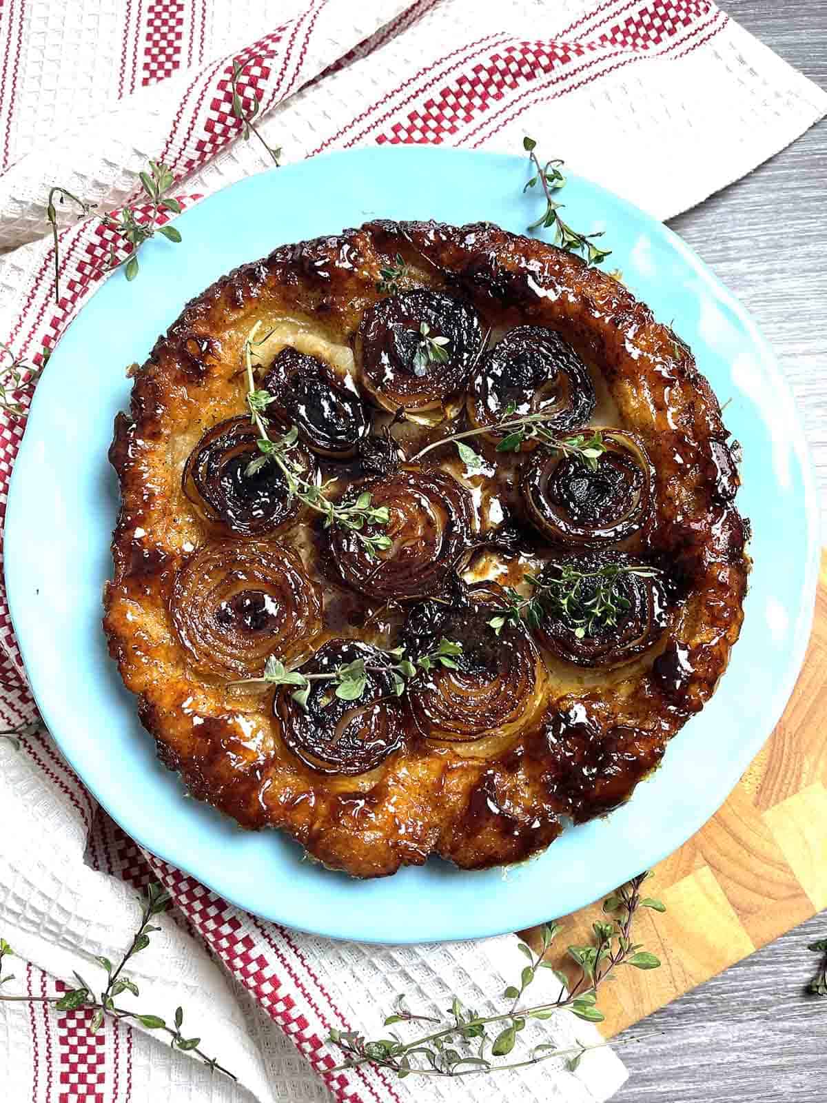 onion tarte tatin on a turquoise plate.