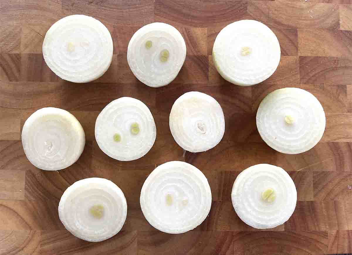 thick sliced onions on a wooden board.