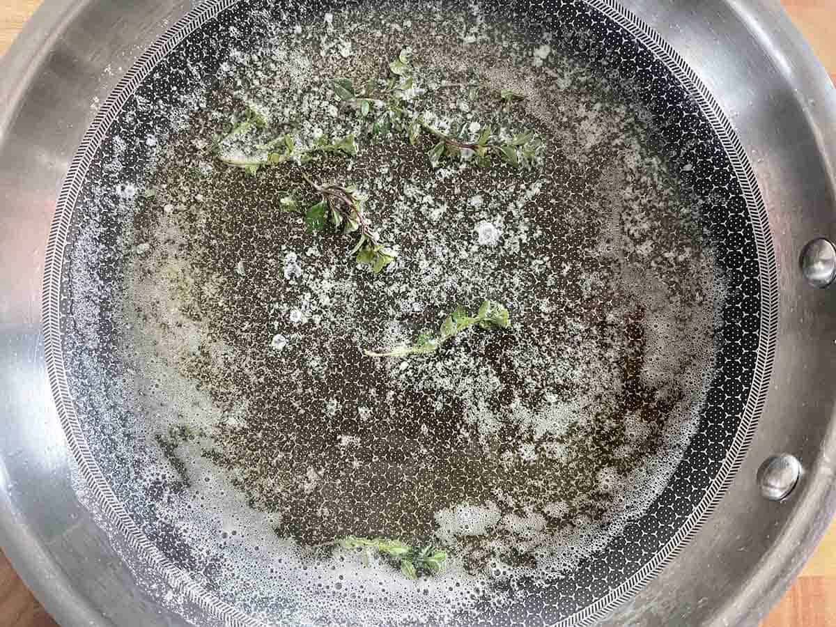 butter, oil and thyme in a frying pan.