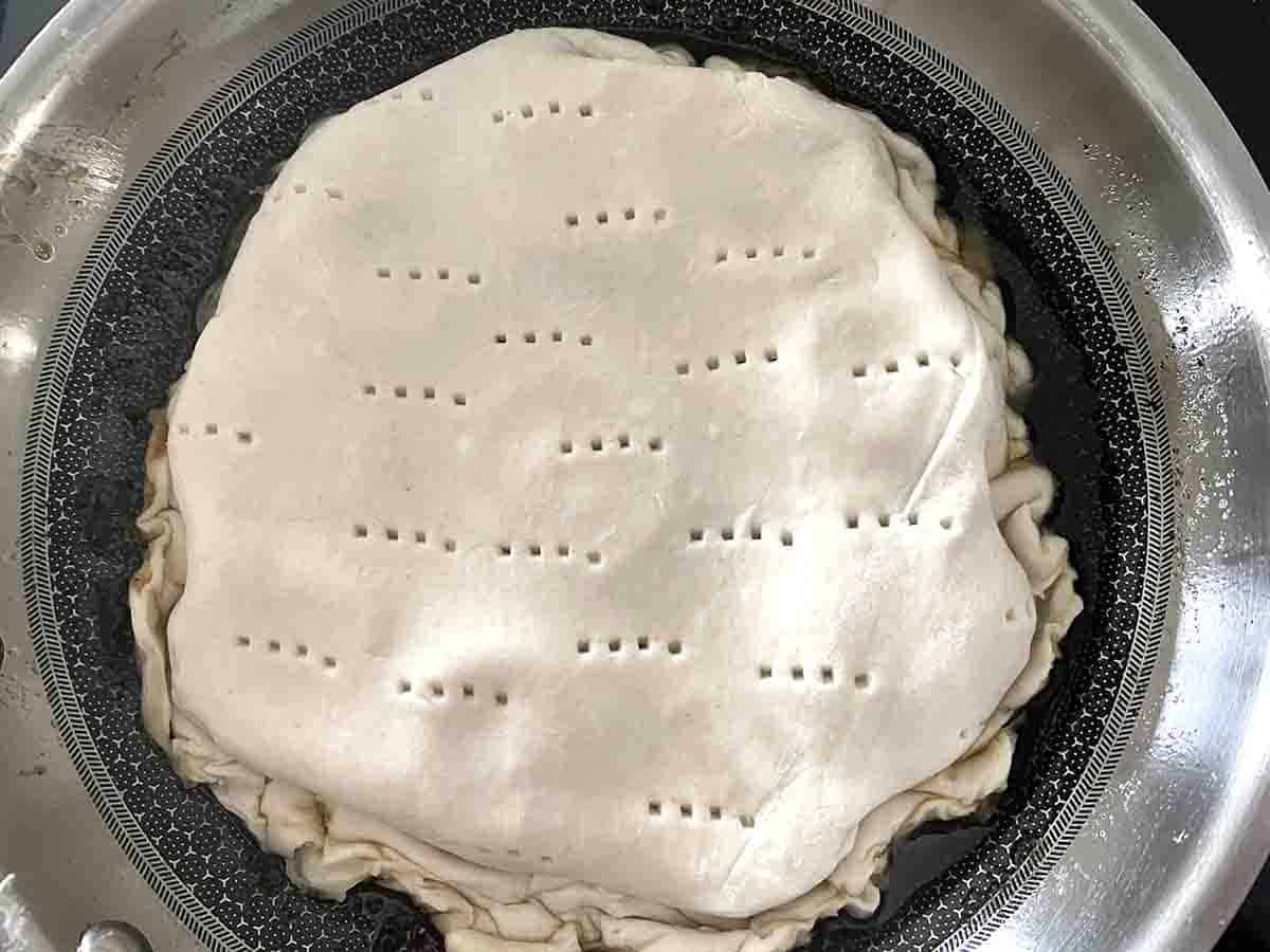 pastry tucked into pan ready for baking.