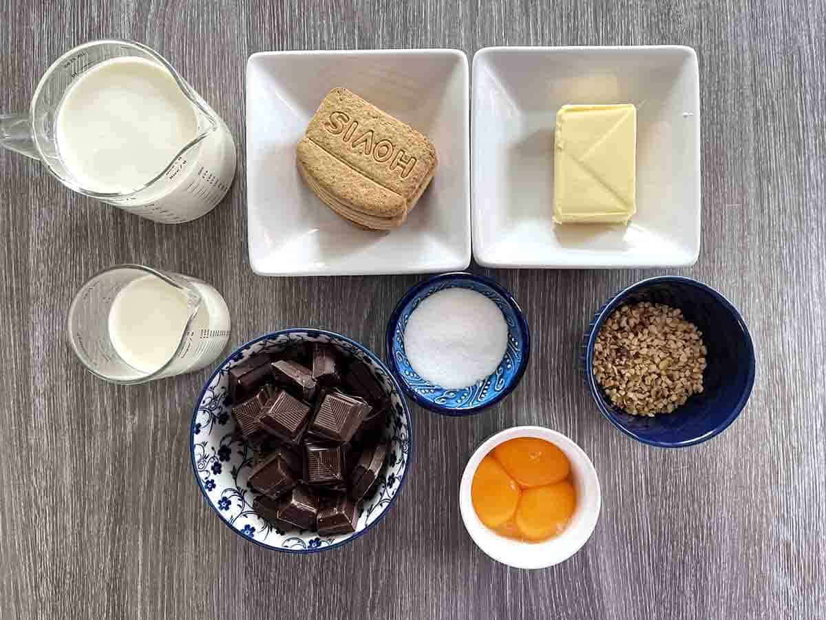 ingredeints in dishes including chocolate, butter, egg yolks, biscuits, sugar, whipping cream and milk.