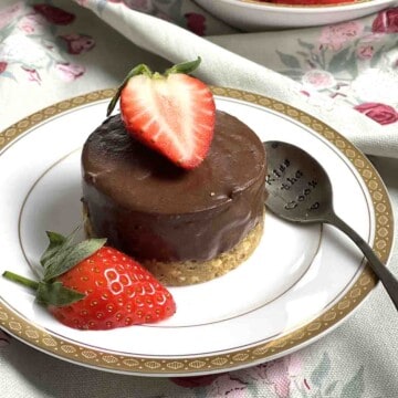 chocolate delice on a plate decorated withhalf a strawberry.