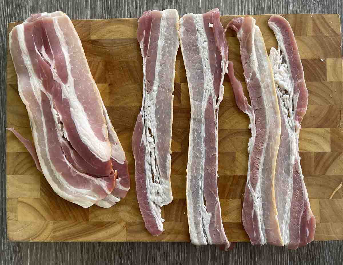 stretched bacon on a board.