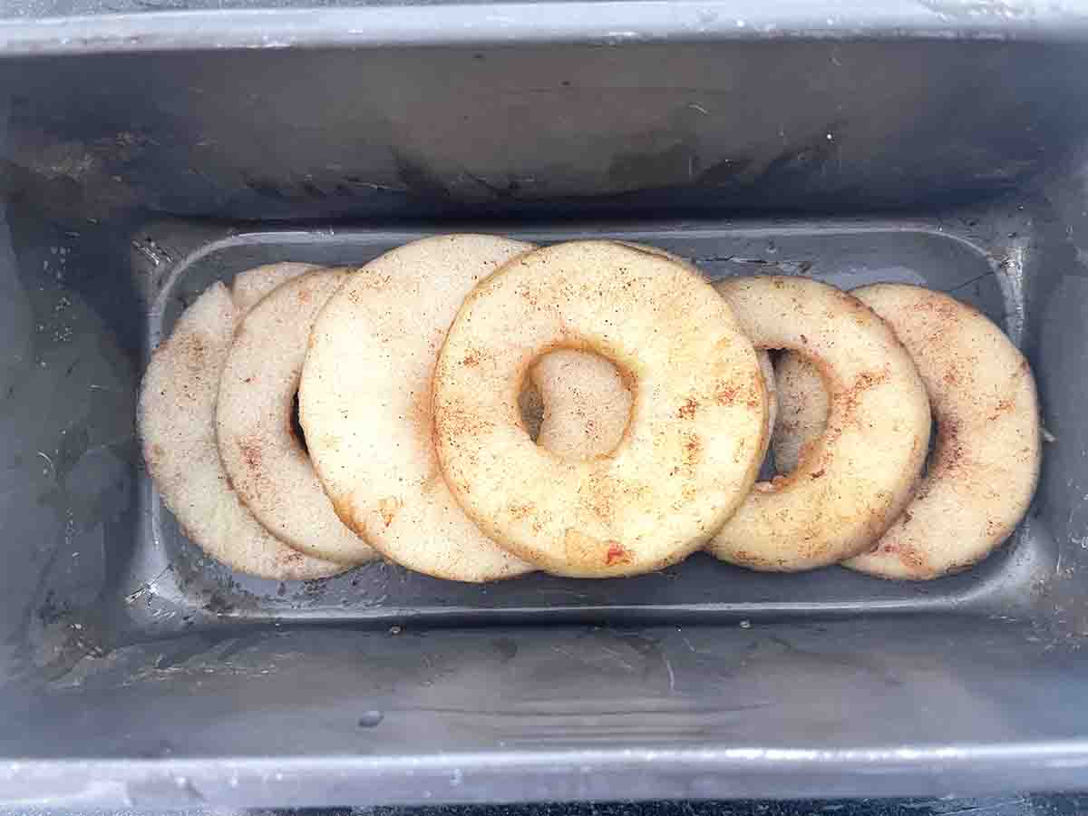 apple slices layered in a loaf tin.