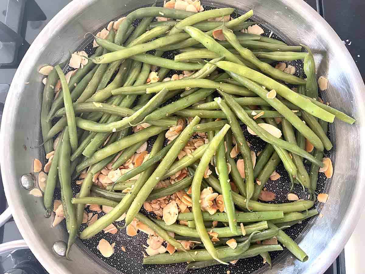 beans and almonds in a frying pan.