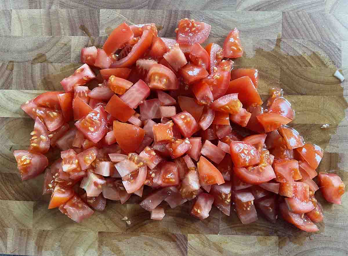 chopped tomatoes on a board.
