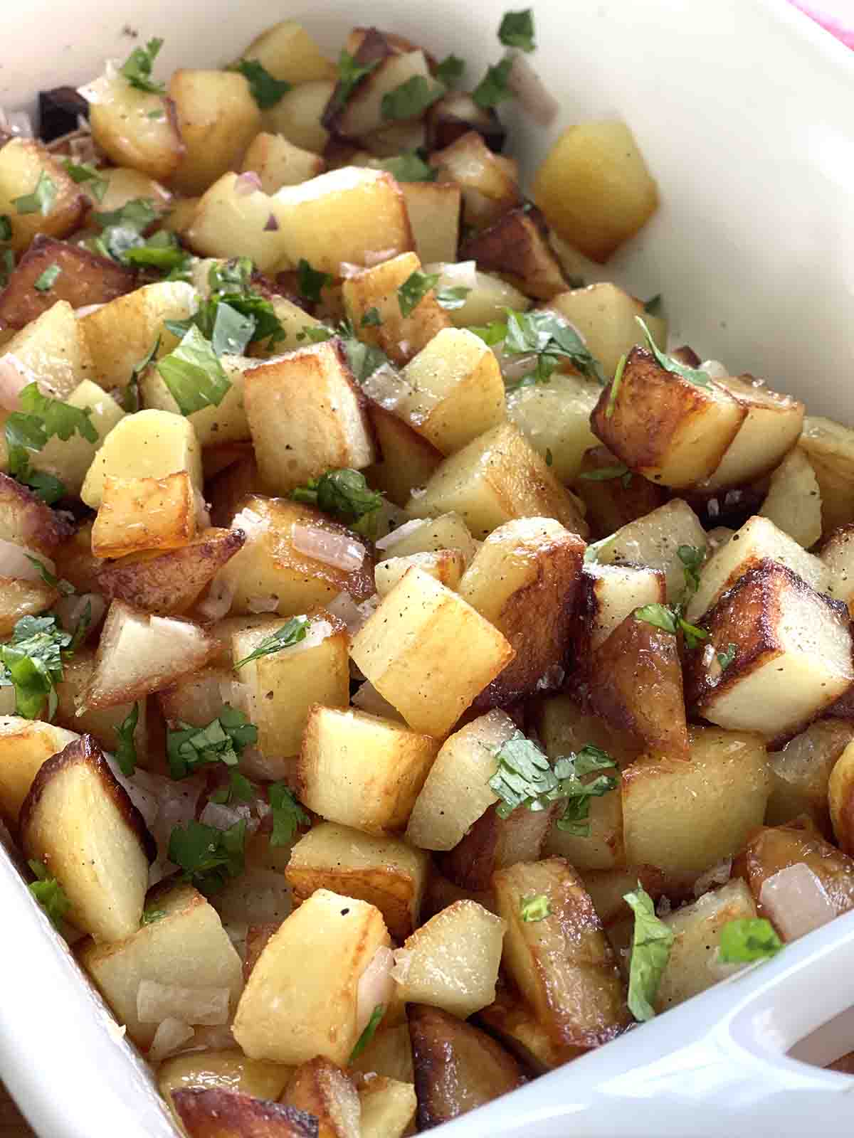 fried crispy cubed potatoes in a serving dish.