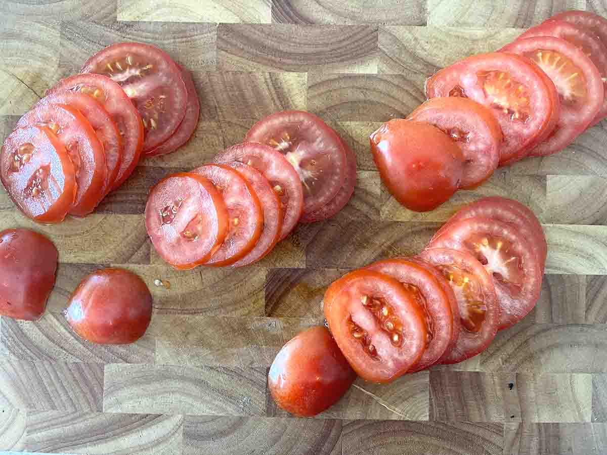 sliced tomatoes on a board.