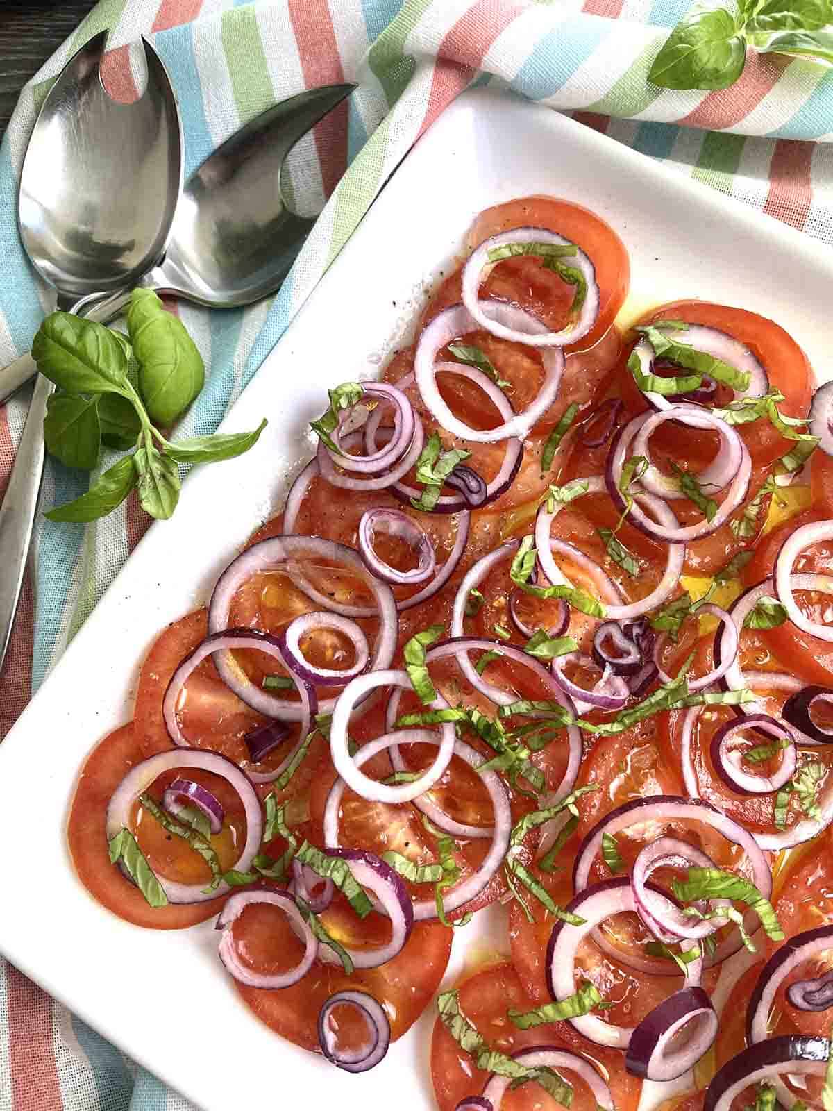 tomato salad on a square plate.
