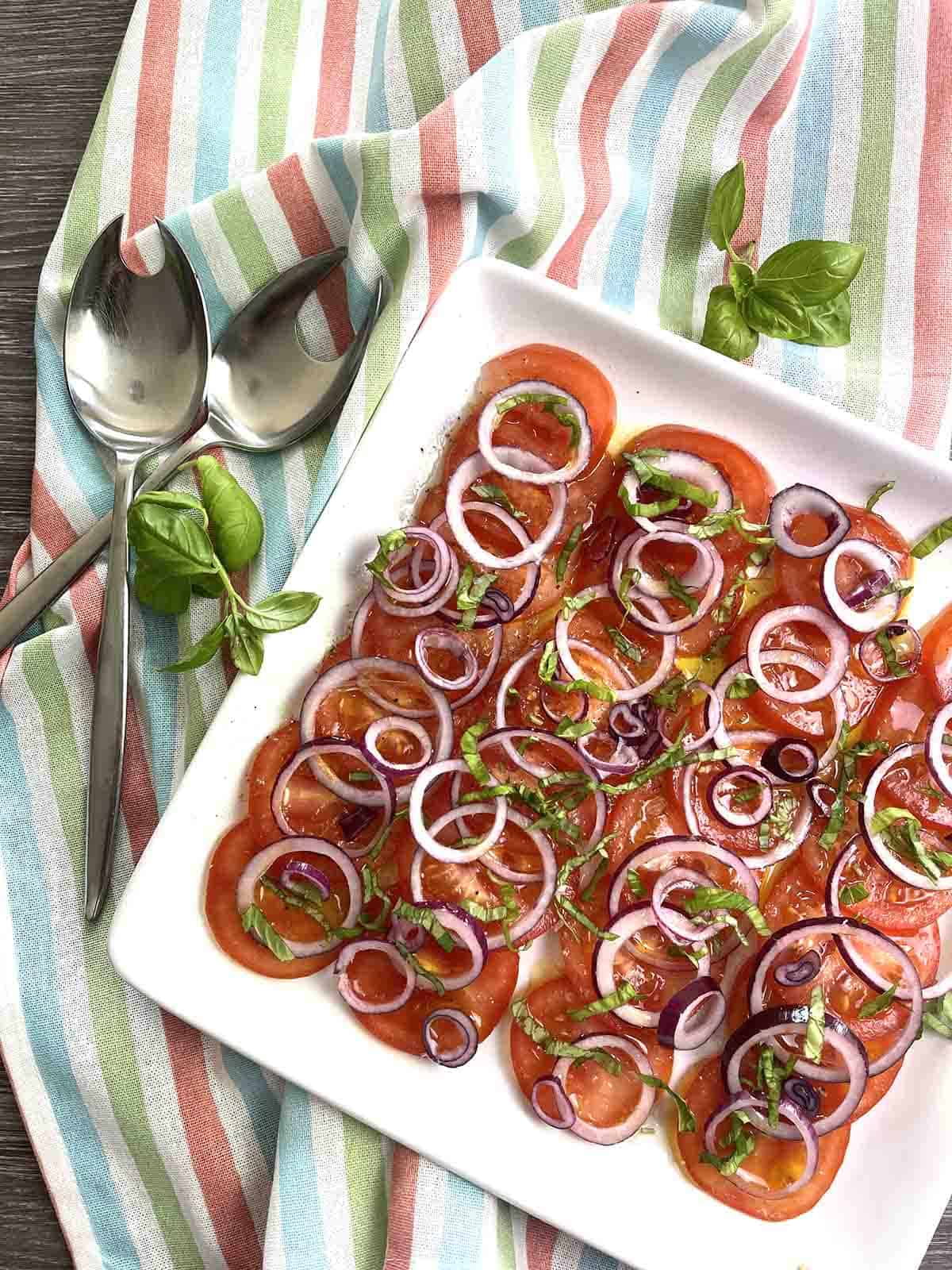 tomato and onion salad on a plate.