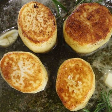 fondant potatoes in a pan.