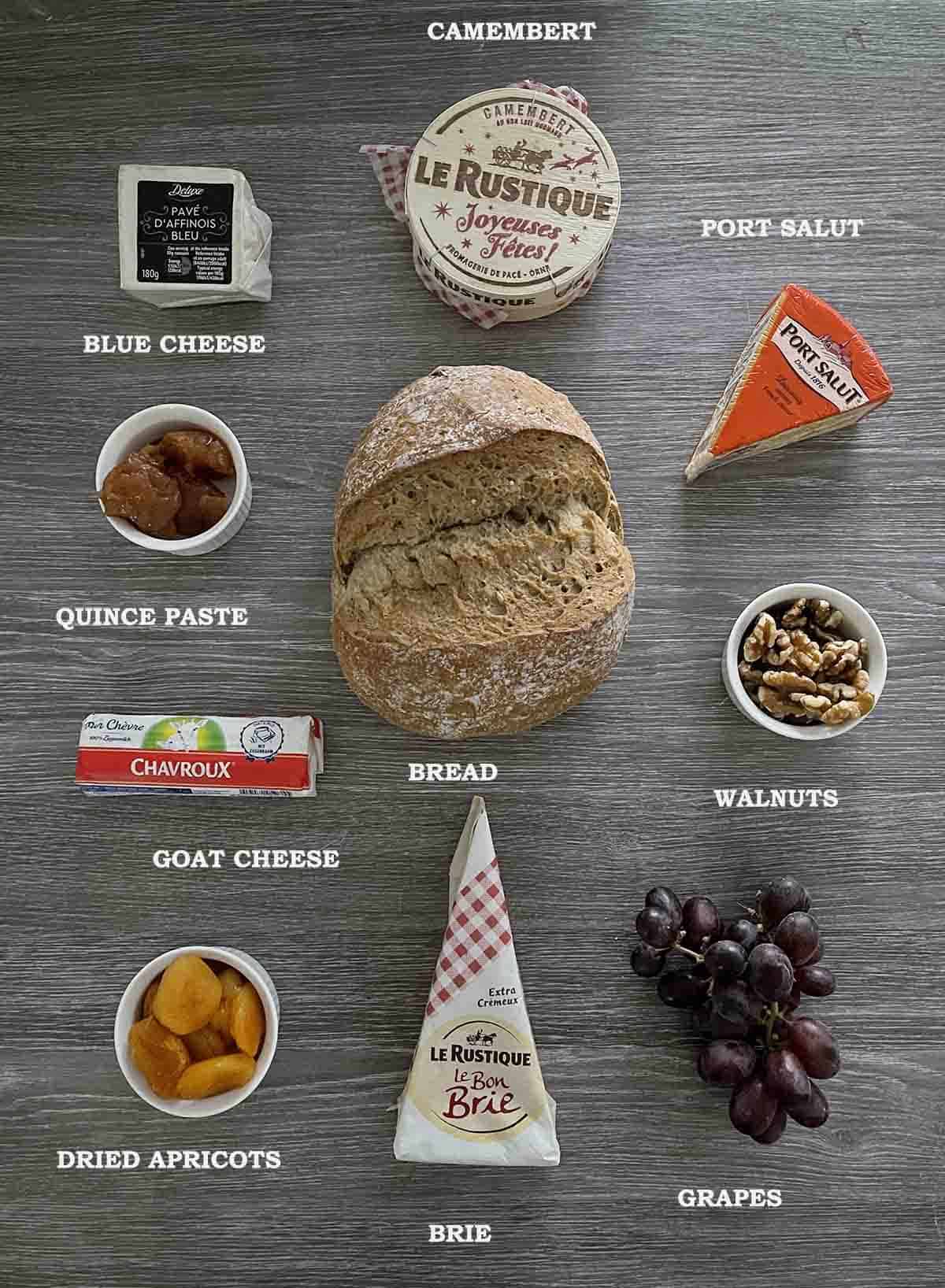 ingredients including cheeses, bread and grapes.