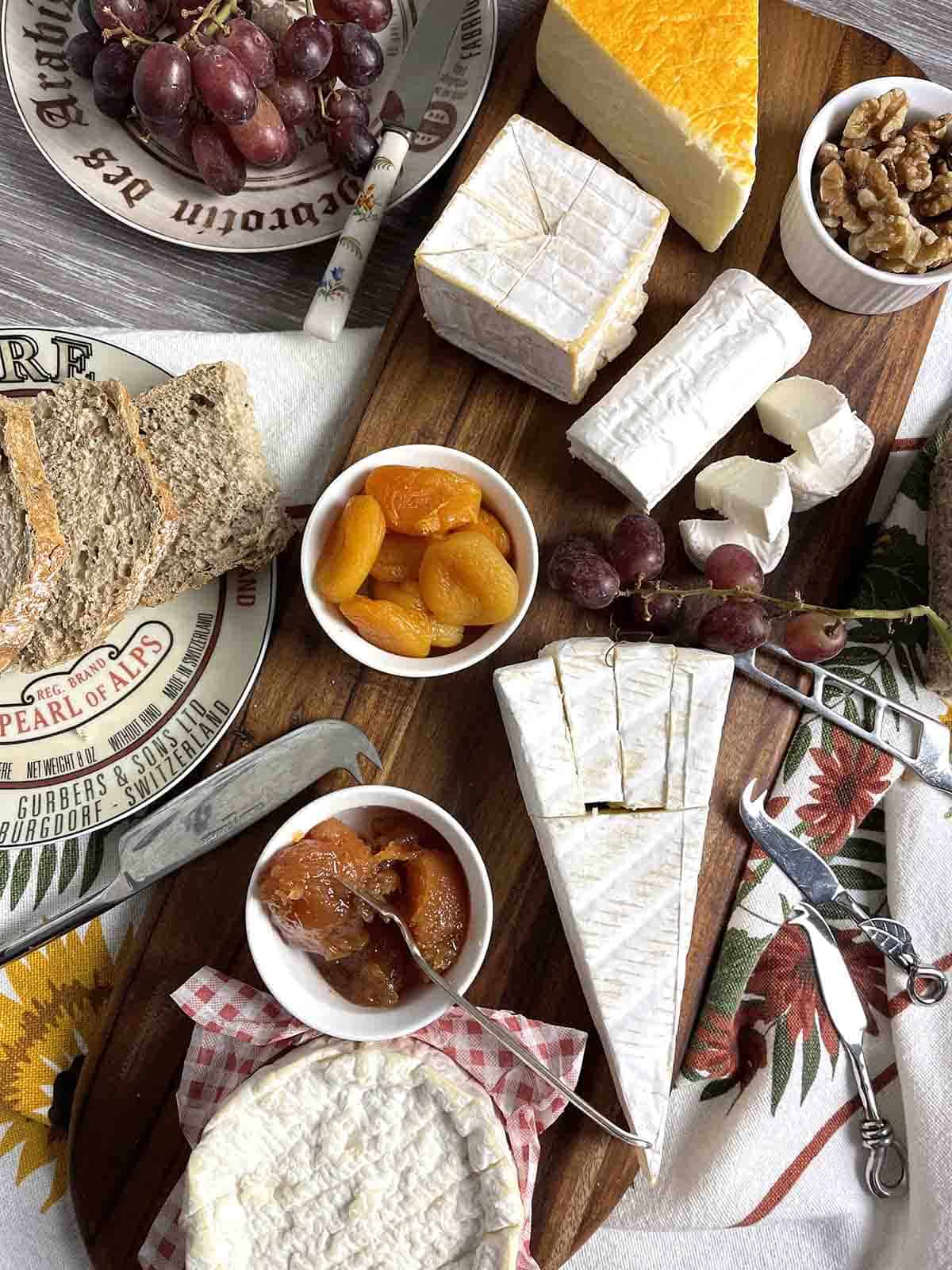 cheese board with cut cheeses.