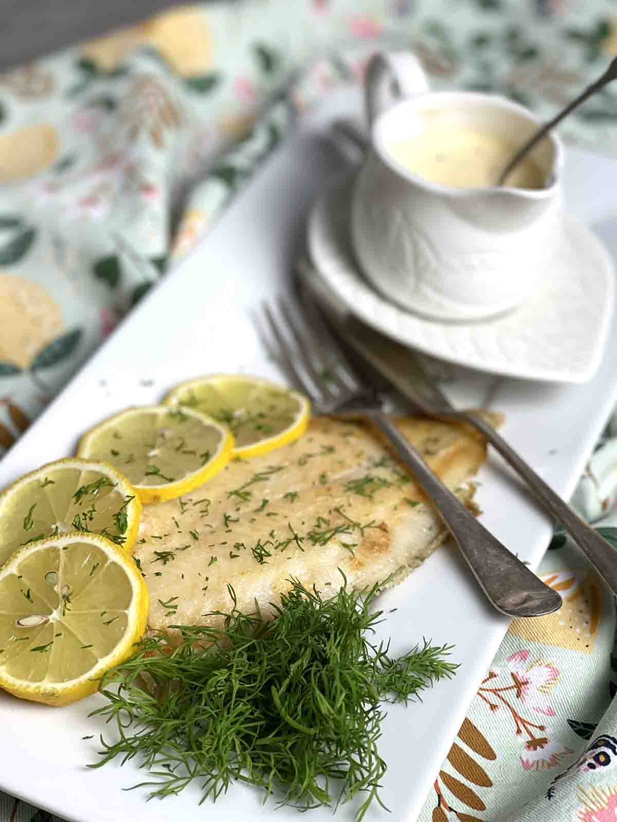 fish on a plate with sauce.