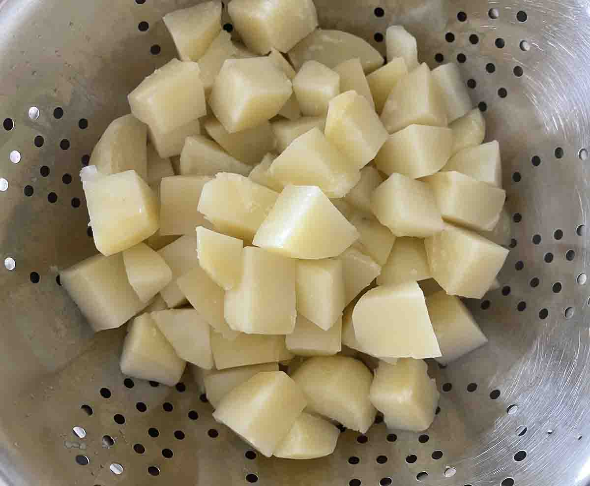cooked potatoes draining.