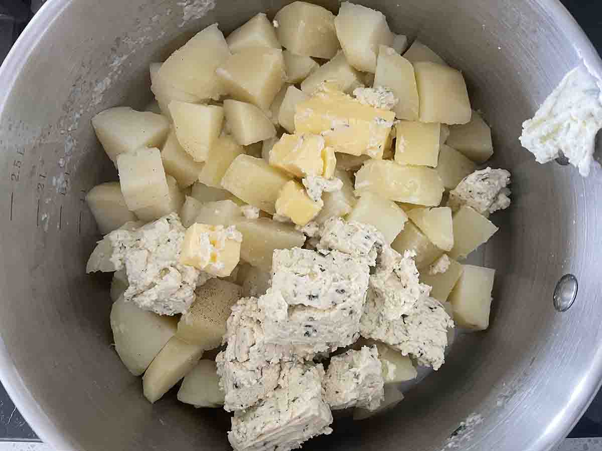potatoes in pan with buter and cheese added.